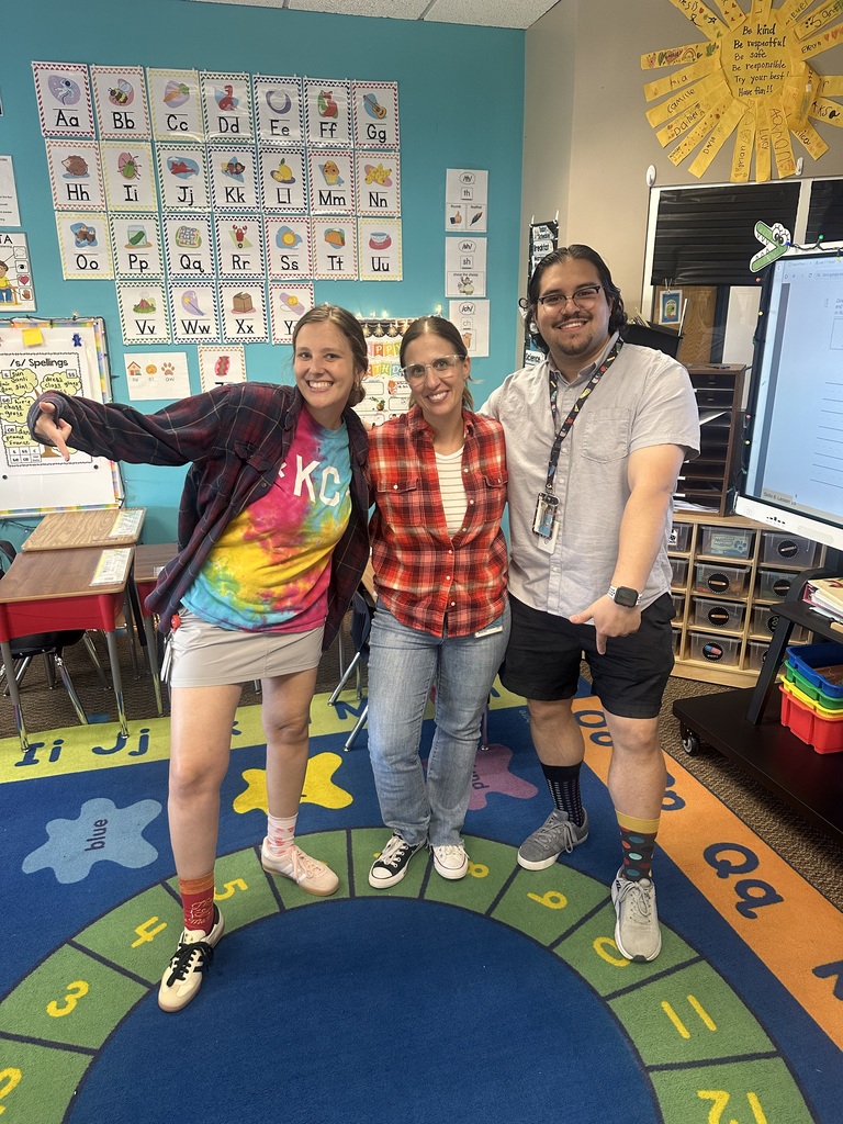 Photo of three teachers participating in a school spirit week “no matching” day, wearing intentionally mismatched outfits
