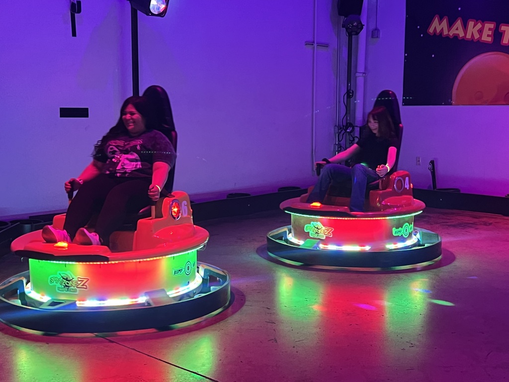 Mrs. Resendiz and a student on bumper cars