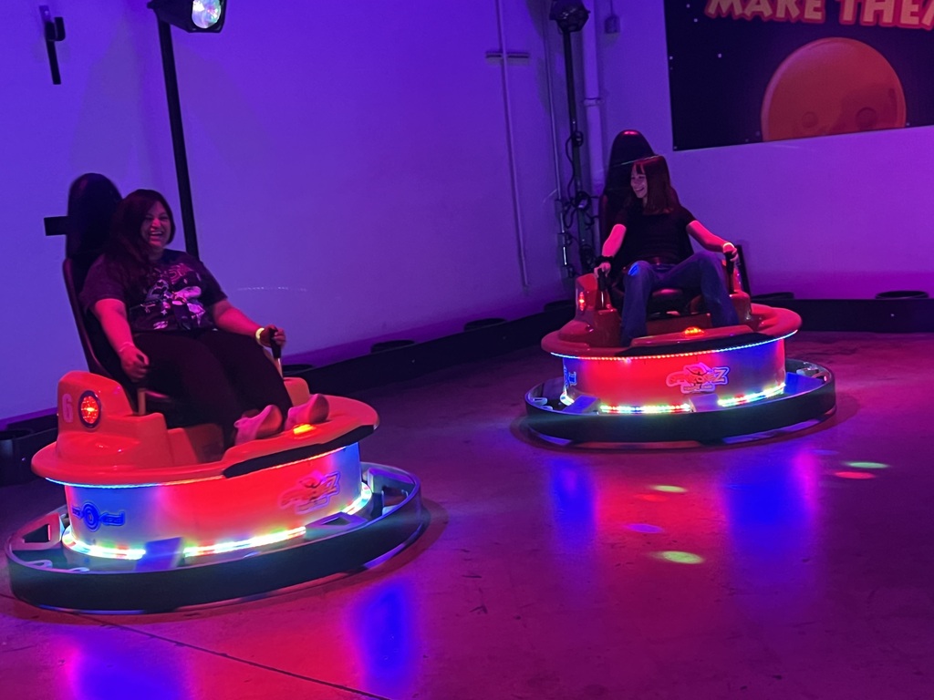 Mrs. Resendiz and a student on bumper cars