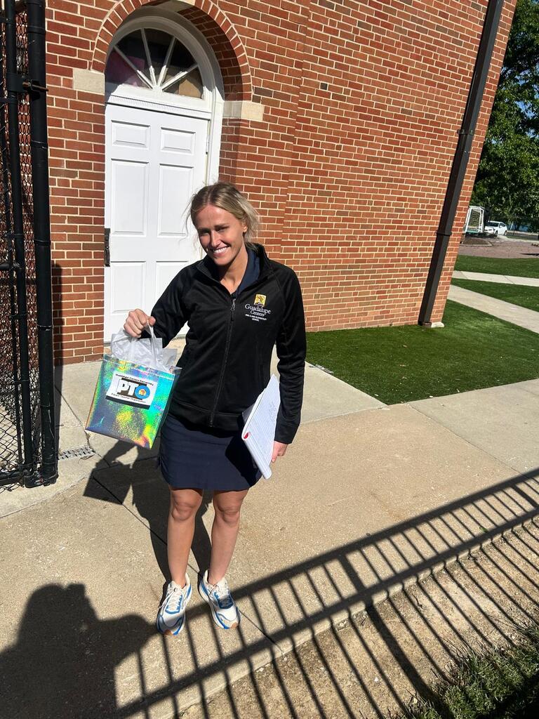 A woman holding a gift bag outdoors