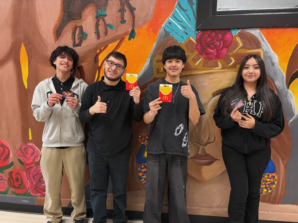a group of students in front of murals