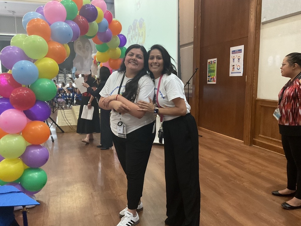 Two Pre-K teachers smiling and ready for the graduation ceremony as their students graduate from Pre-K.