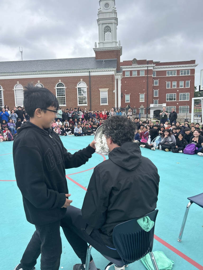 Student putting the whipped cream plate in the face of teacher