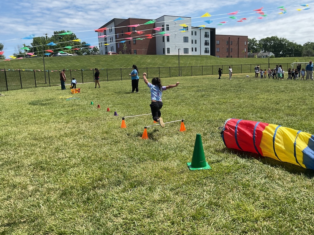 A child jumping over an obstacle course
