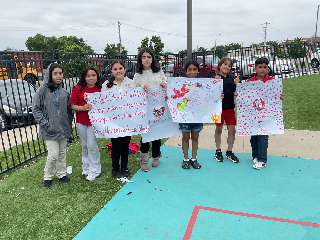 6 girls and 1 boy holding signs