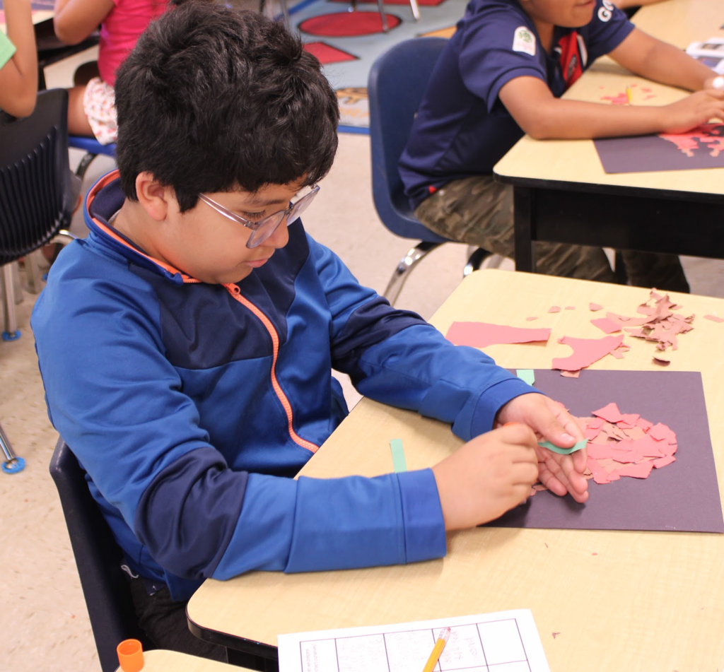 3rd grade student cutting paper