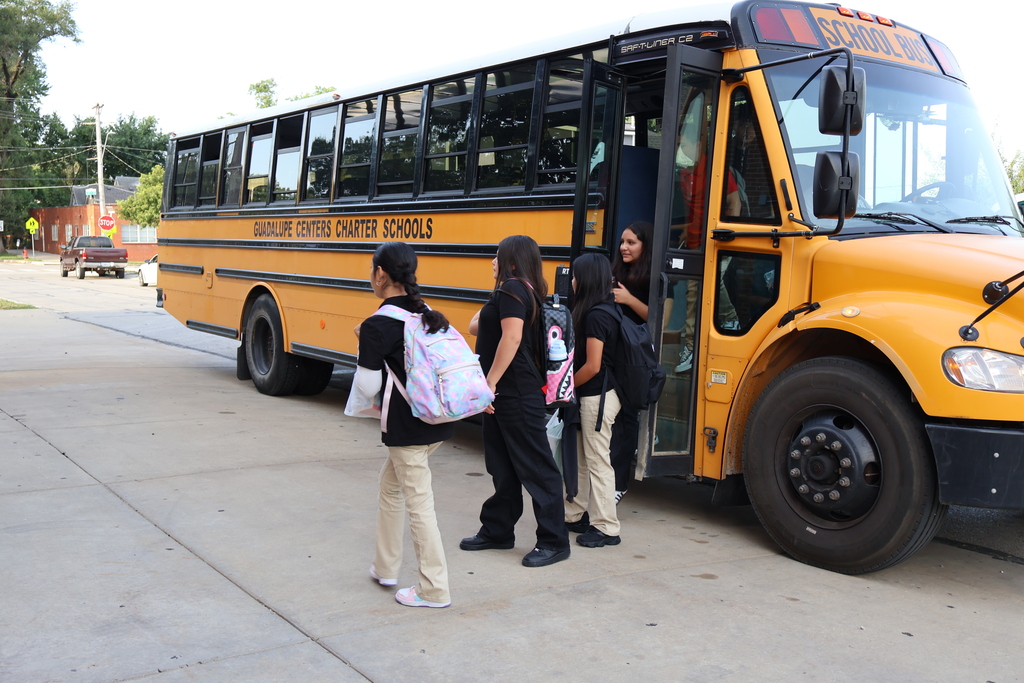 students in 6th grade getting off the bus in the morning and making their way to the building 