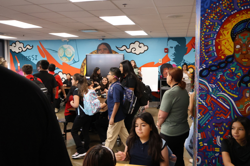 students in 6th grade are all gathered up in the cafeteria waiting to be dismissed