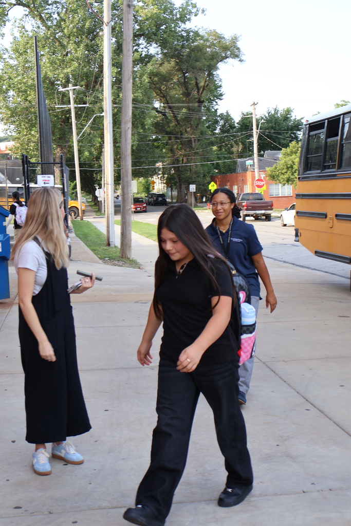 student in black uniform walking to the cafeteria 