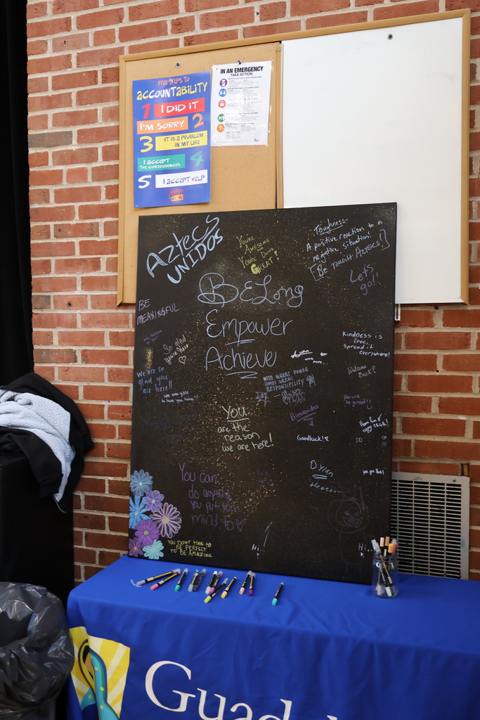 black board with neon letters on the table with blue cloth 