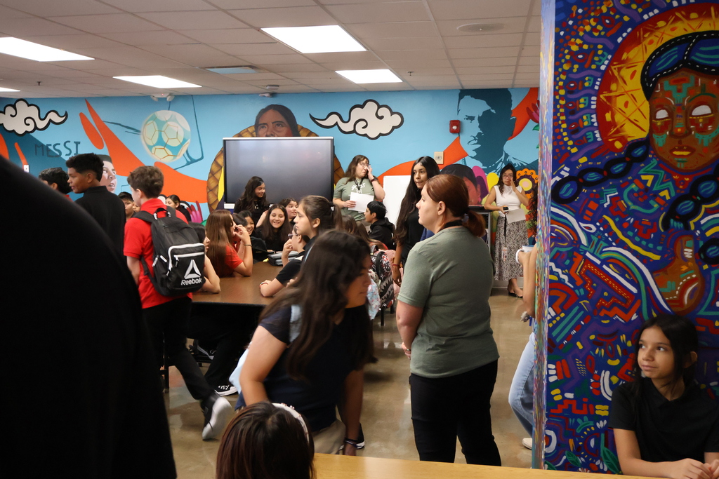 students in 6th grade are all gathered up in the cafeteria waiting to be dismissed