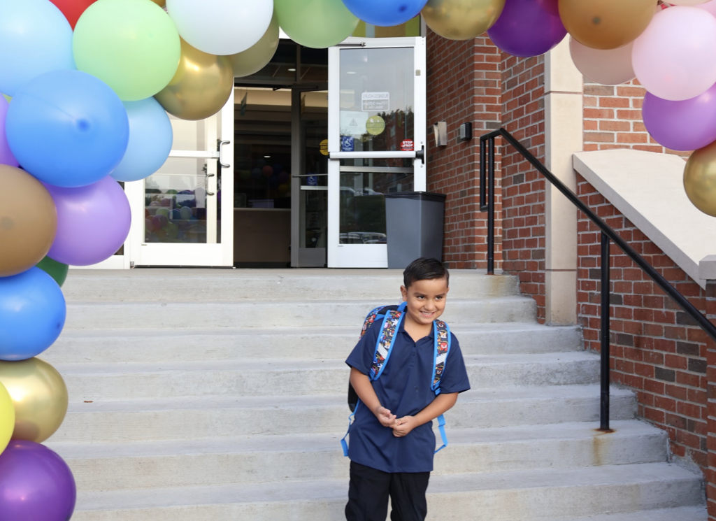 Student in front of the gces entrance