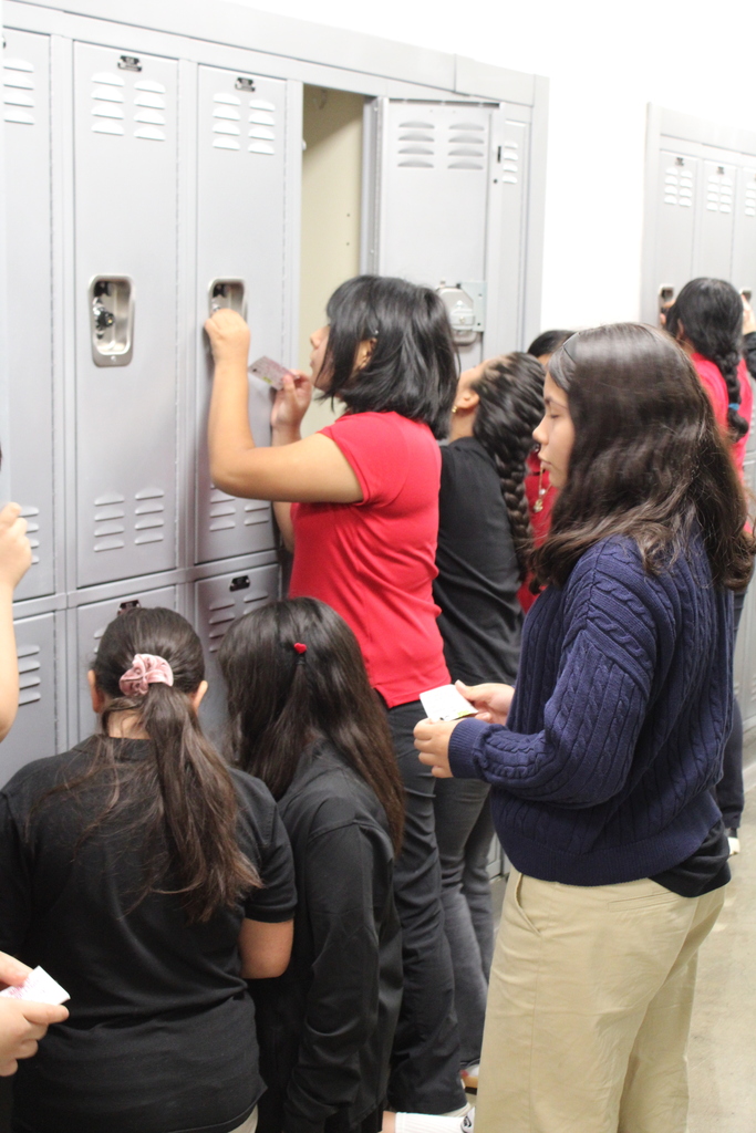 students learning how to open up their locker