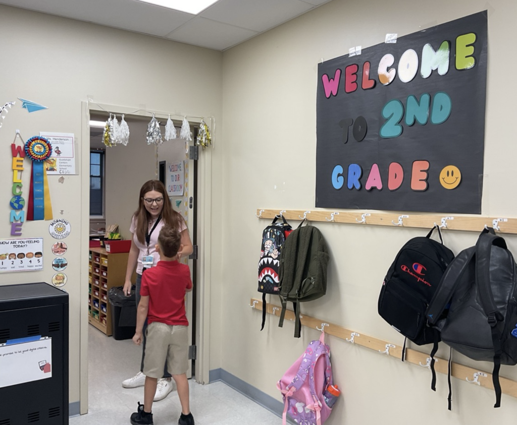 2nd grade student fist bumping teacher