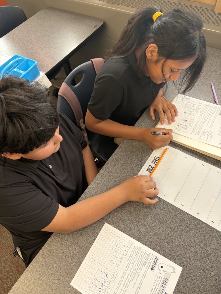 students working together to record data on their papers