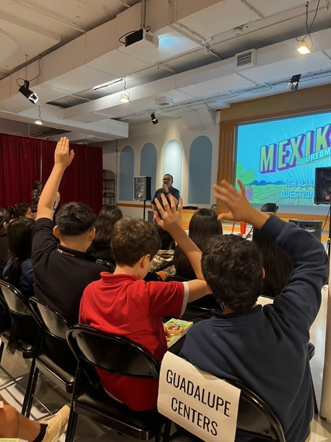 students raising their hands