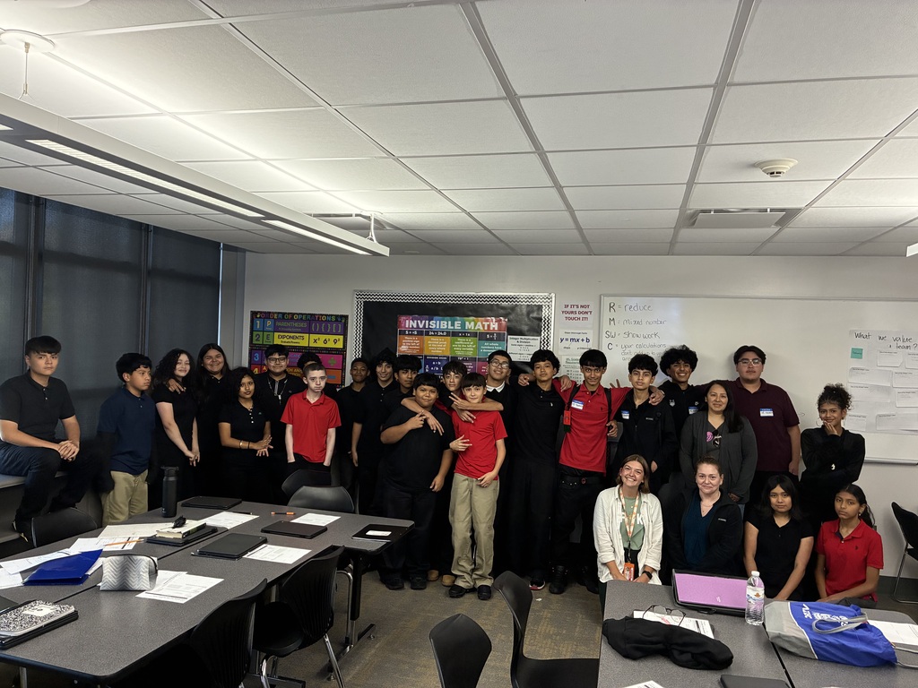students in uniform standing as a group for a picture.