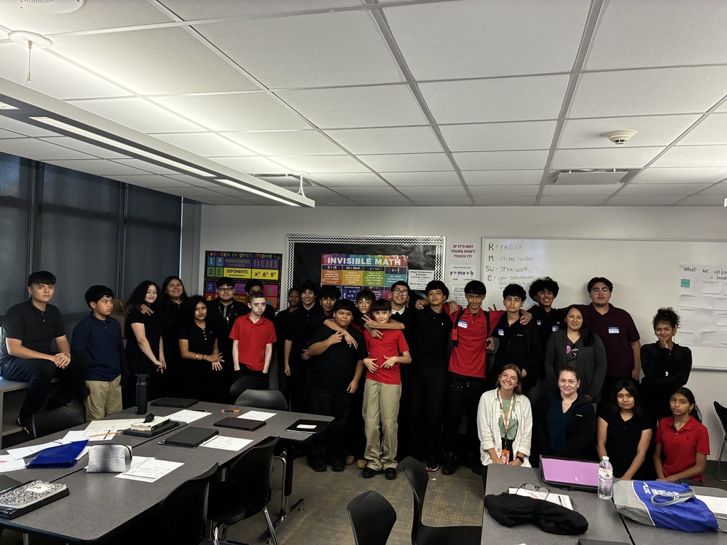 students in uniform standing as a group for a picture.