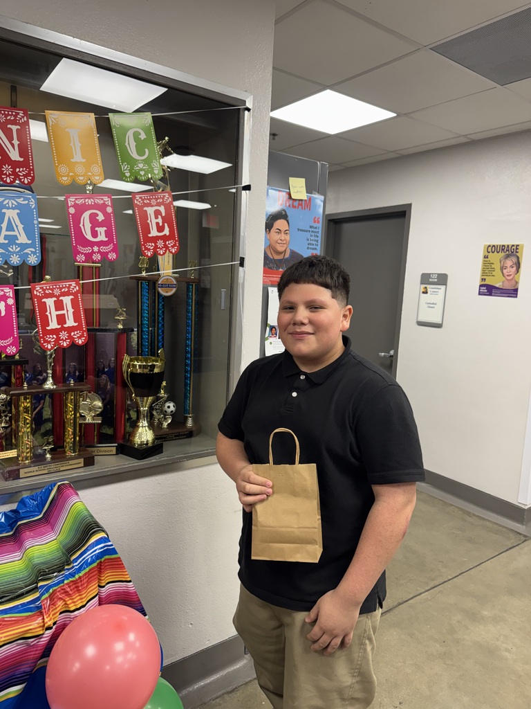 student in black holding up his goodie bag