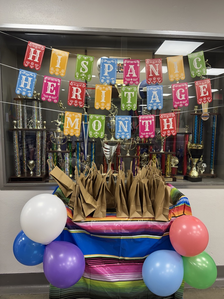 color ful background that say hispanic heritage month and with goodie bags on the cart