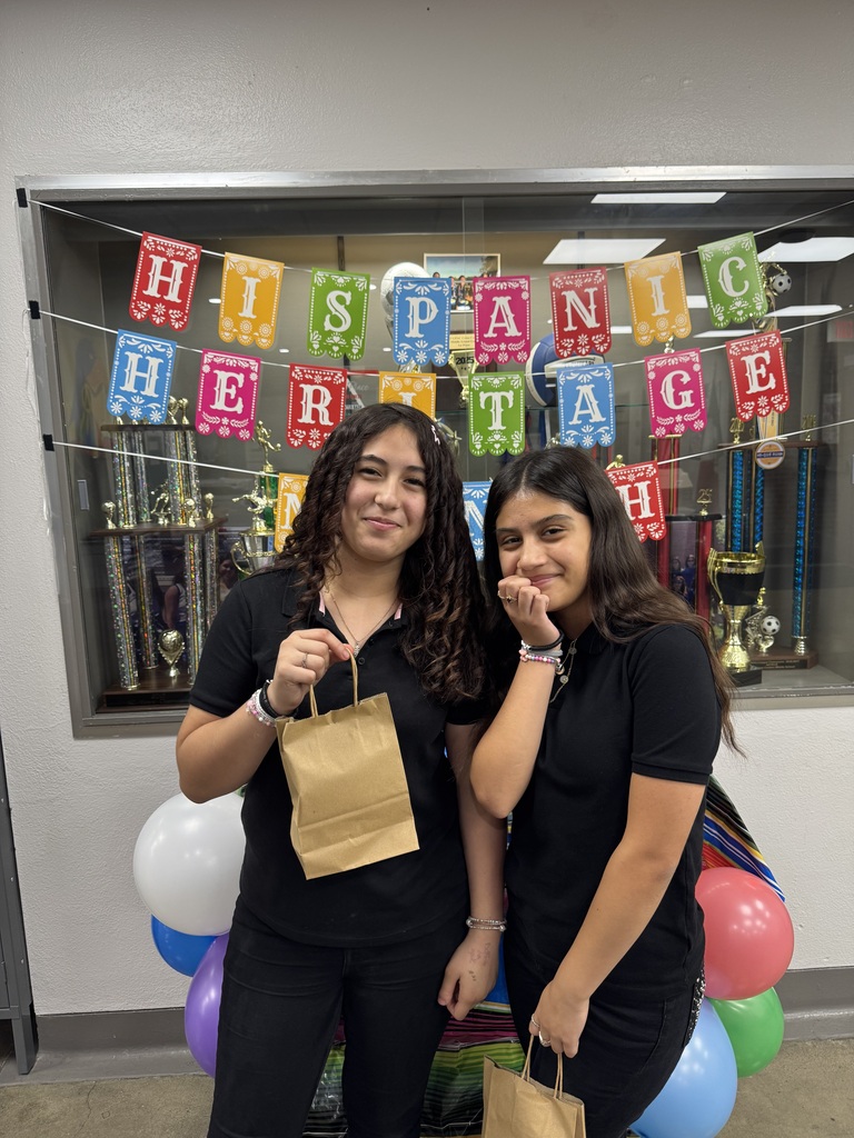 two friends holding up their goodie bags