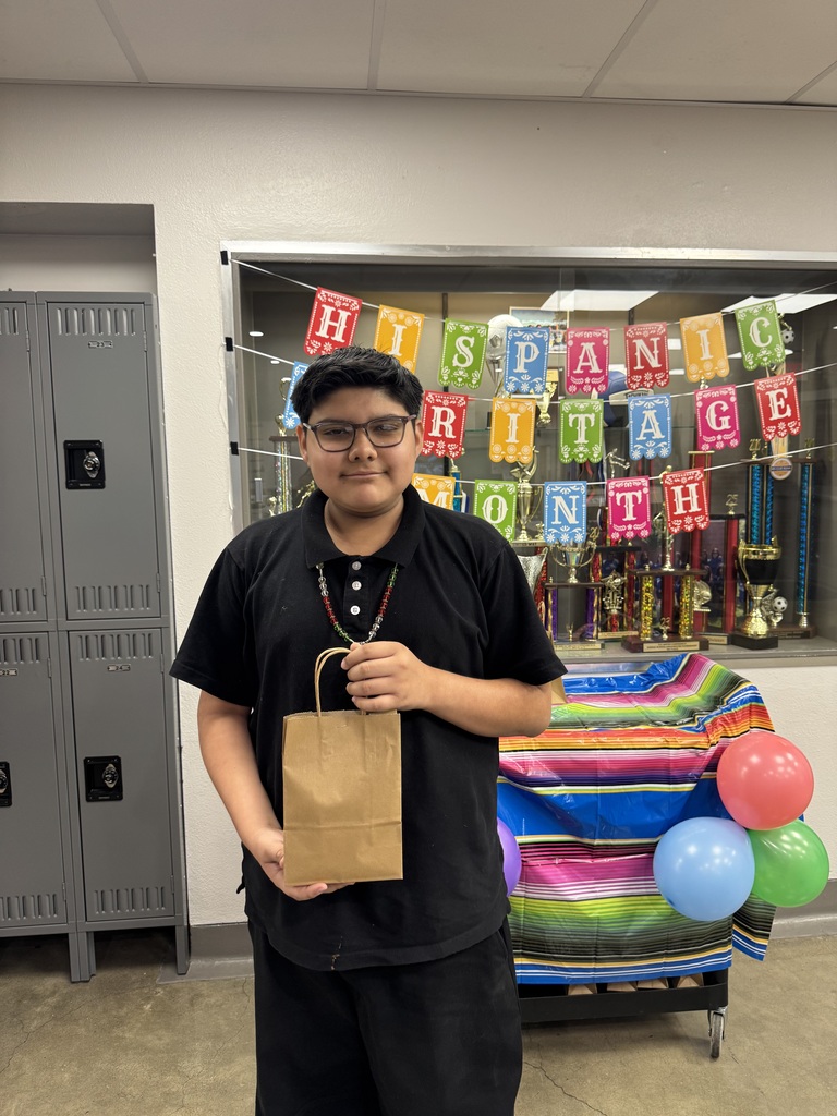 student in black holding up his goodie bag