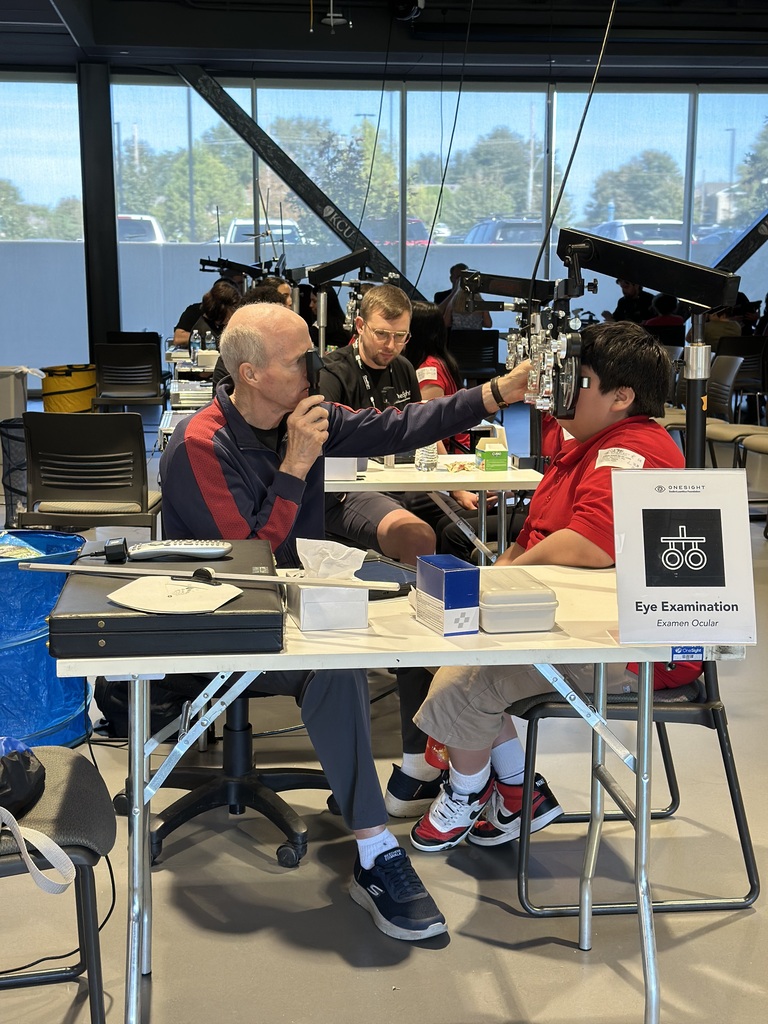 student in red polos getting his eyes checked