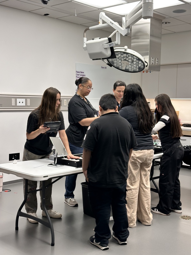 students standing patiently picking out their glasses frames
