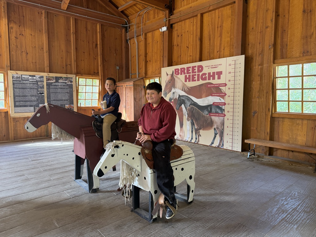 students riding a plastic horse