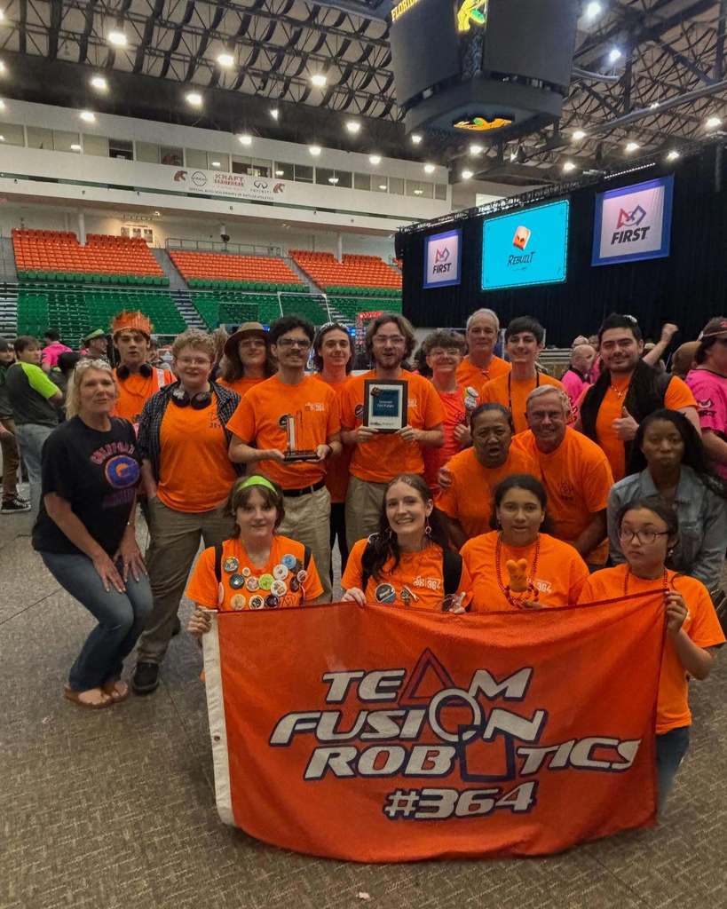 Team Fusion Robotics #364 group photo holding a banner for winning at the Tallahassee robotics tournament.
