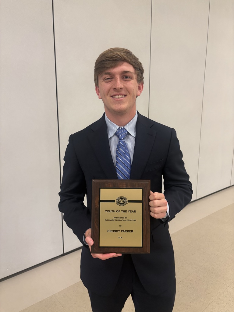 Crosby P. holds wooden plaque recognizing him for Youth of the Year by the Exchange Club of Gulfport. 