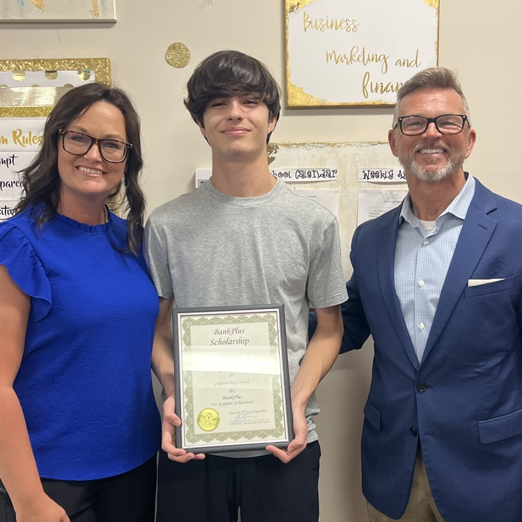 Layton F. receives the BankPlus scholarship with representatives from the bank. 