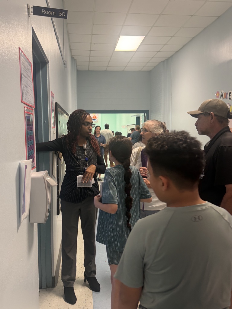 Parents and students visiting with Mr. Dedeaux, a 5th grade teacher
