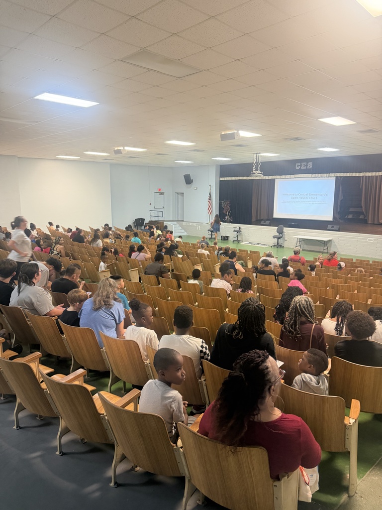 Parents and students listening to our annual Title I meeting in our auditorium
