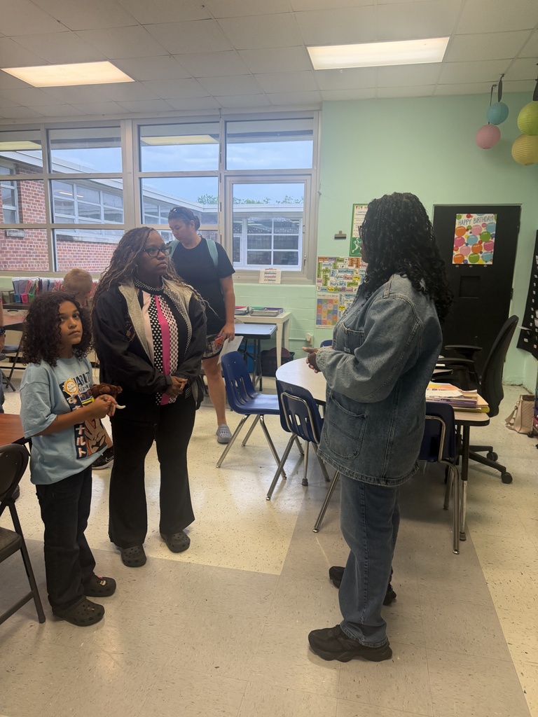 Parents and students visiting with Ms. Diaz, a 4th grade teacher
