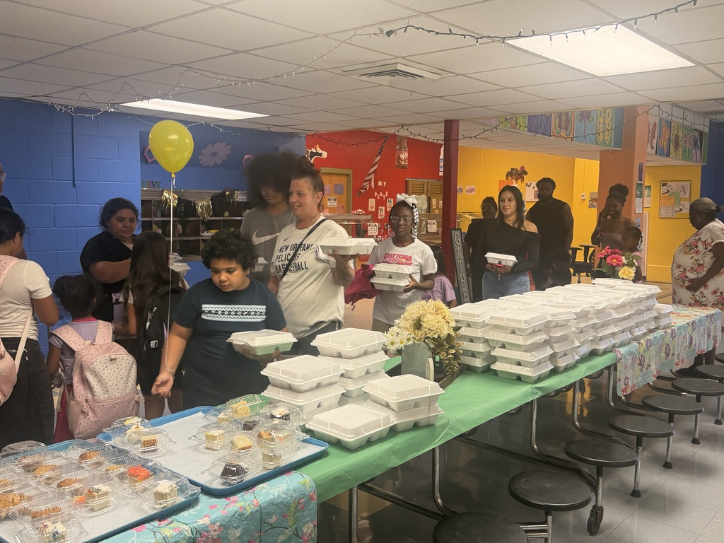 Parents and students picking up their to-go spaghetti dinner from our cafeteria