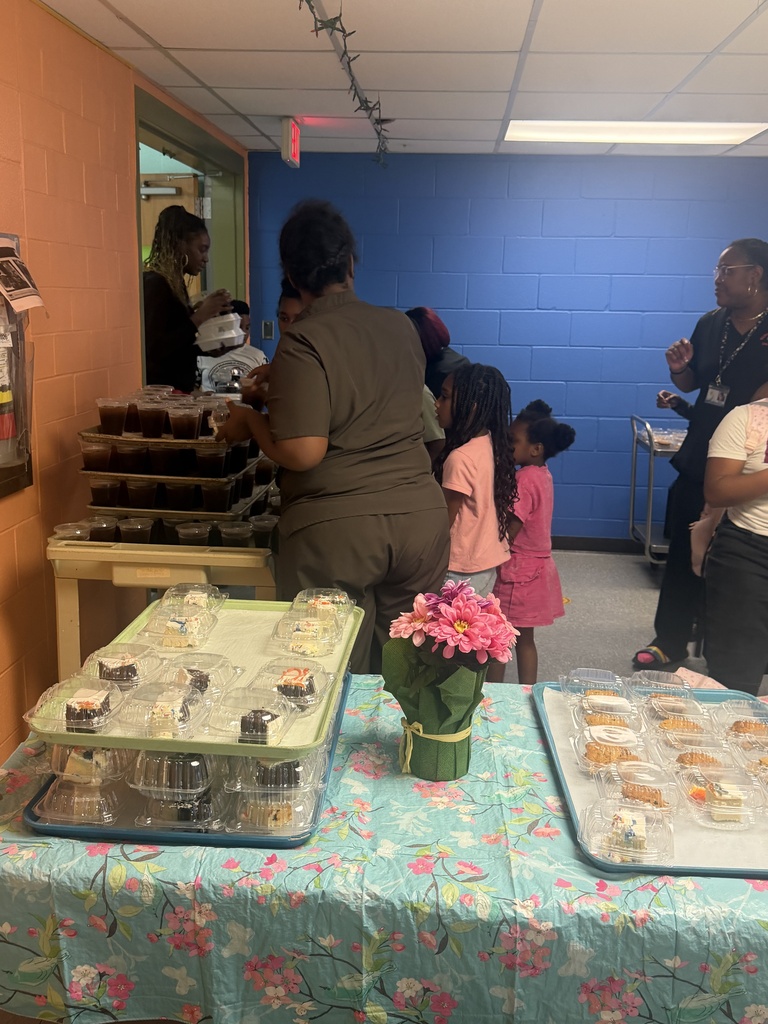 Parents and students picking up their to-go spaghetti dinner from our cafeteria