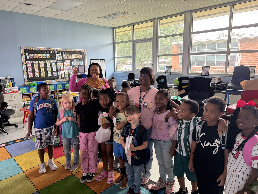 Mrs. Turner and Ms. Swims, posing for a picture with many of Ms. Swims's students