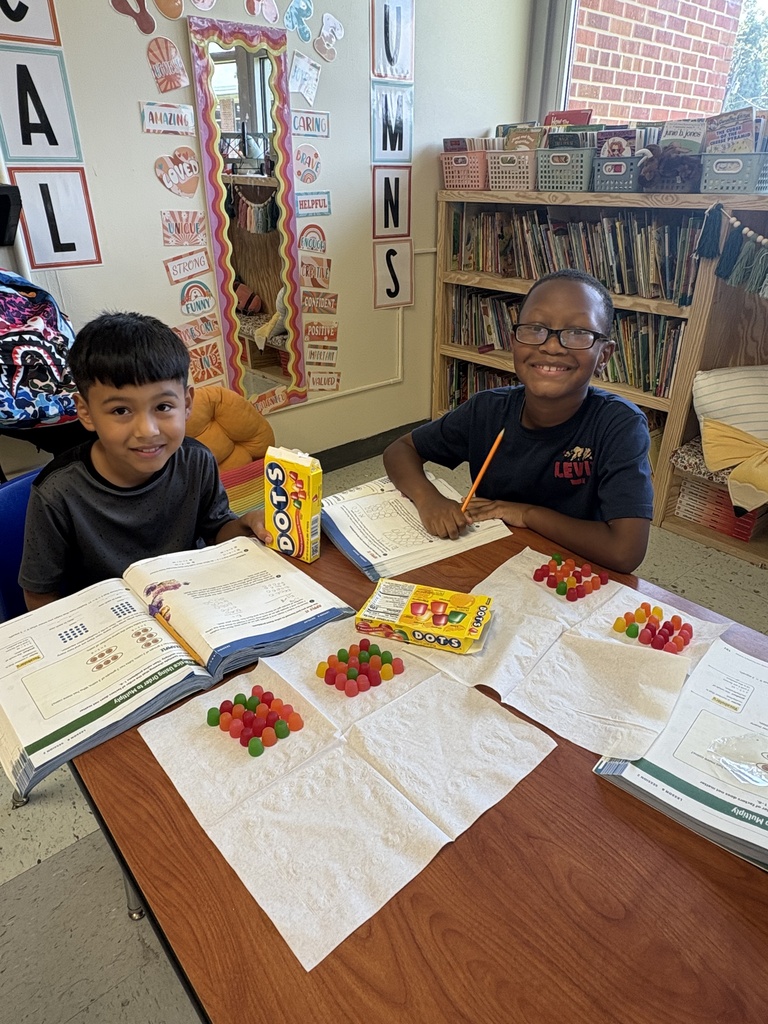 Two students showing their arrays they built with Dots candy
