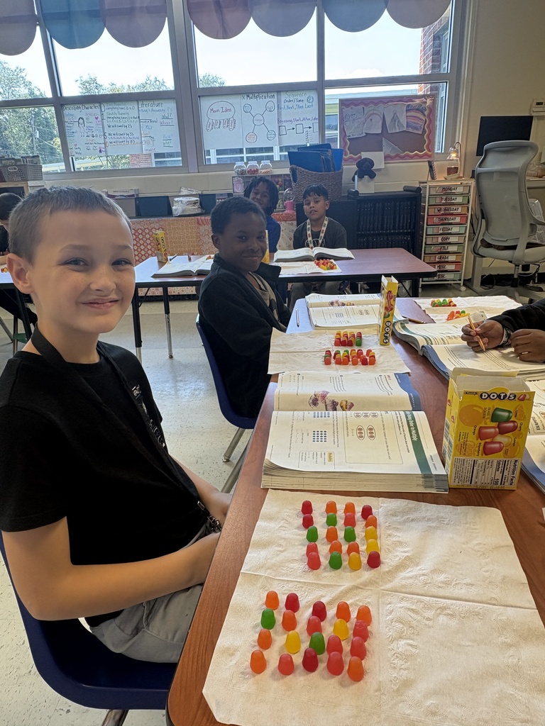 Two students showing their arrays they built with Dots candy