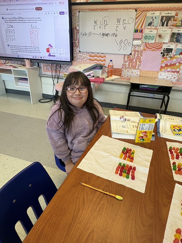 A student showing the arrays she built with Dots candy