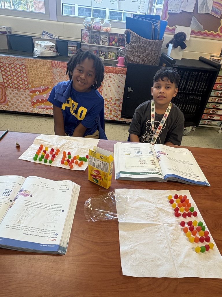 Two students showing their arrays they built with Dots candy