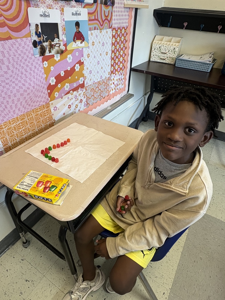 A student showing his array he built with Dots candy