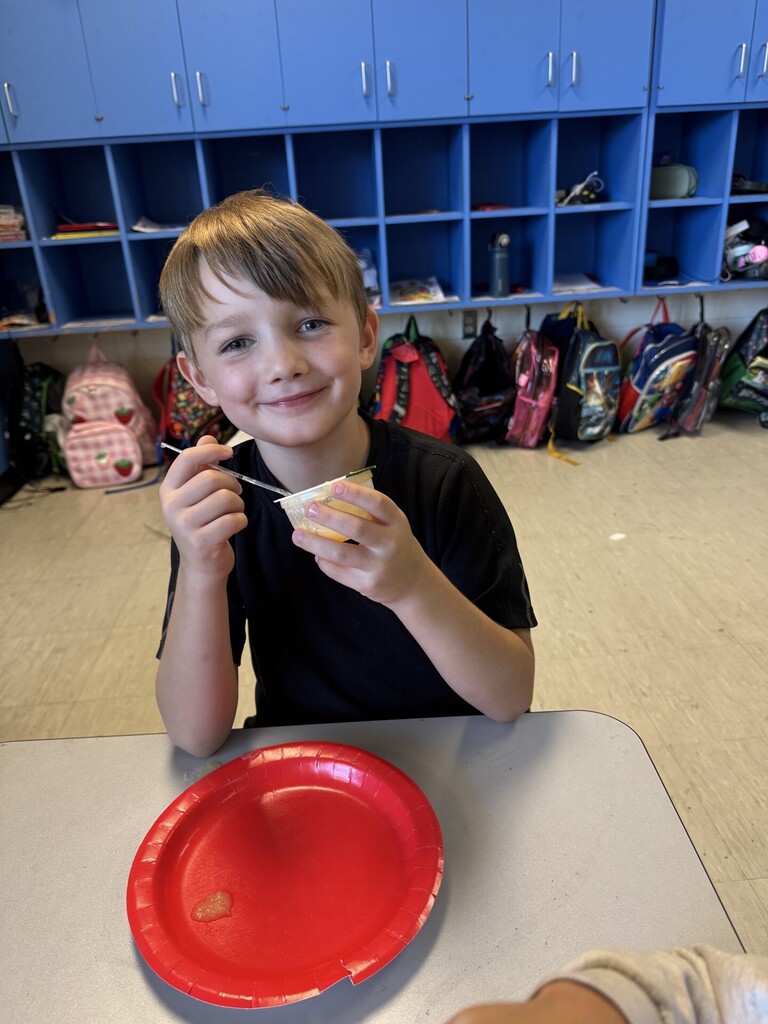 A student tasting the apples