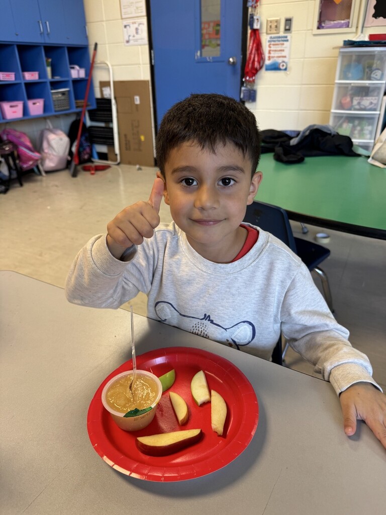 A student tasting his apples