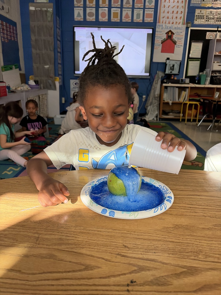 A student completing a science experiment by making an apple volcano