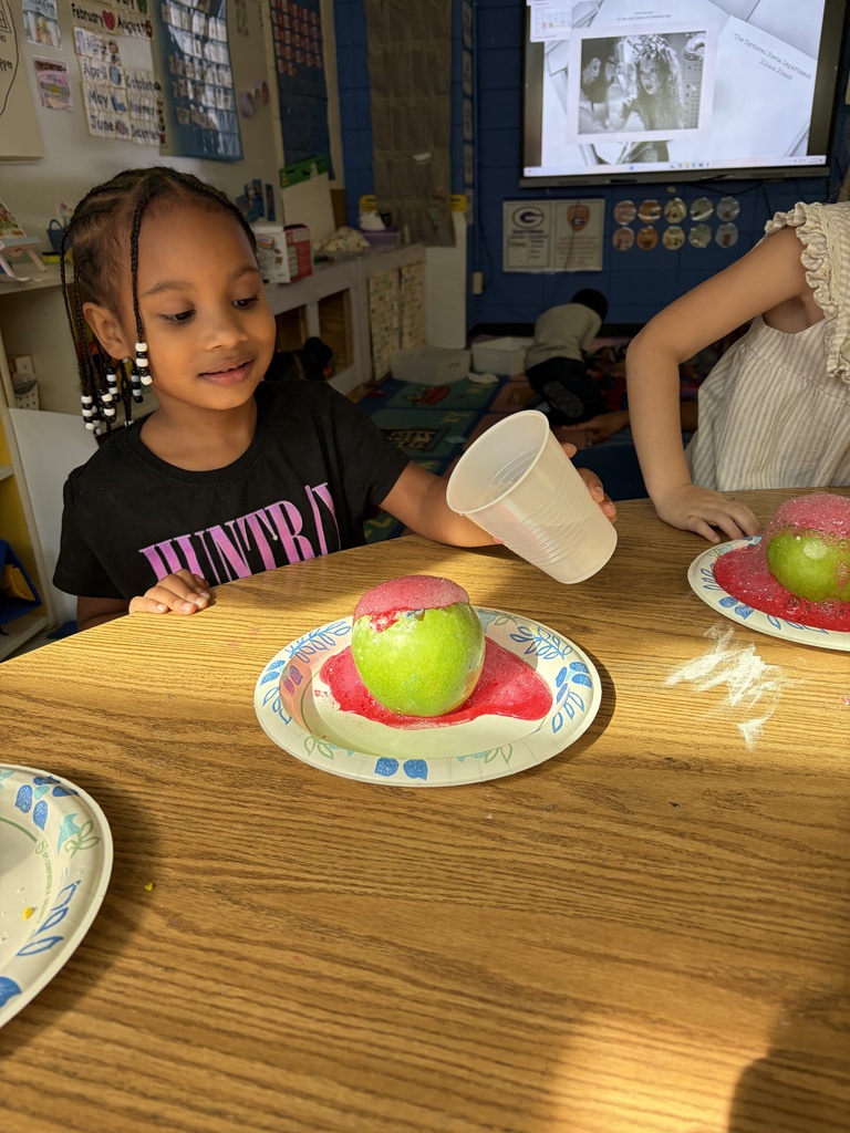A student completing a science experiment by making an apple volcano