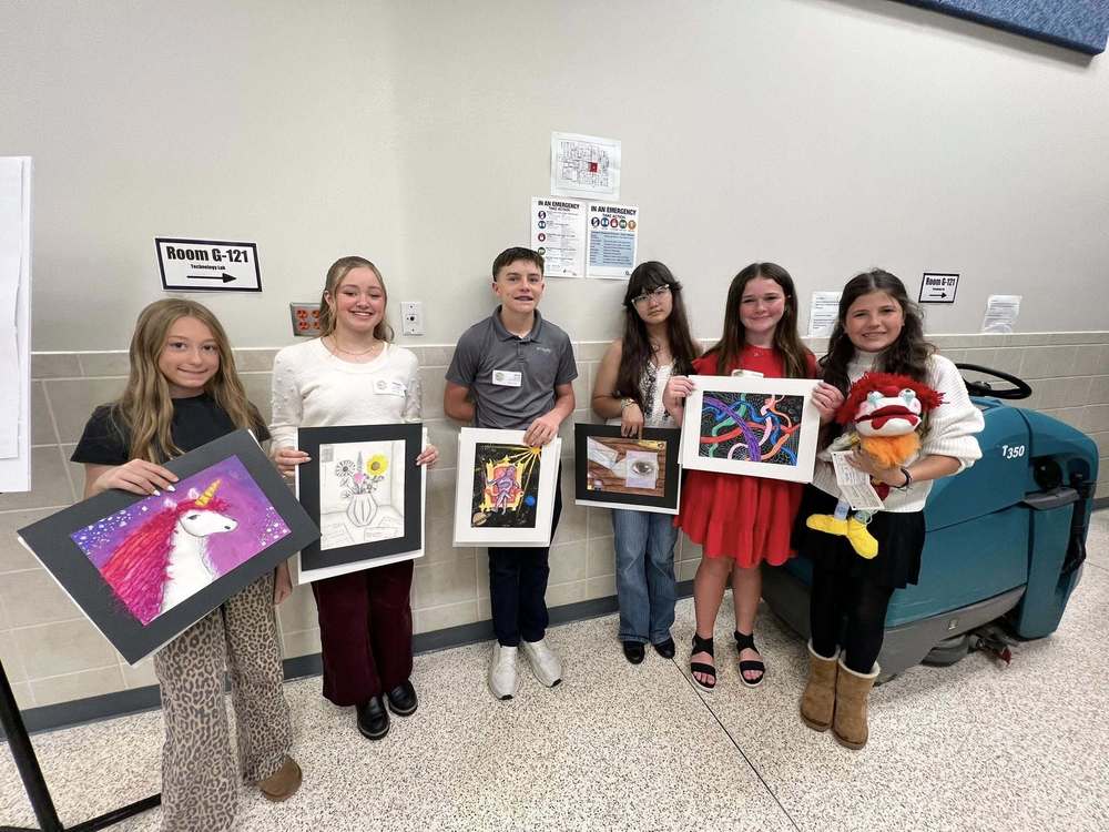 6 students holding art