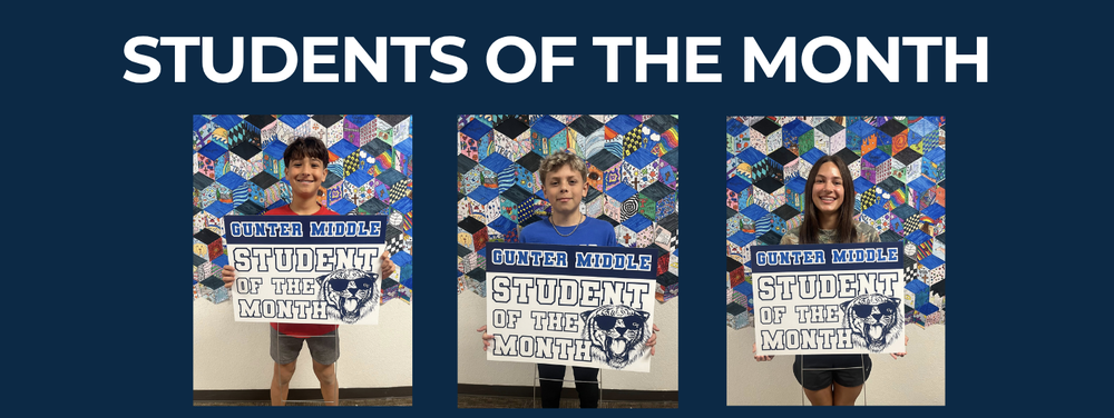 3 students of the month standing holding signs