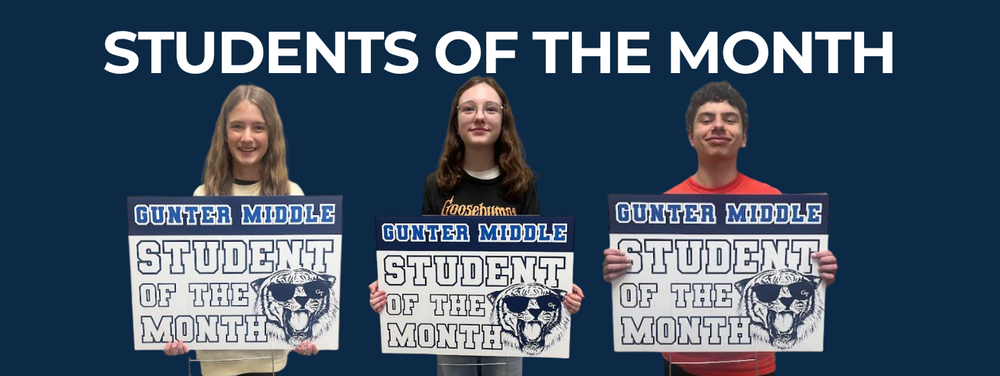 three students holding student of the month posters.